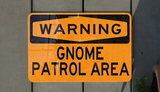 a yellow and black street sign on a wall