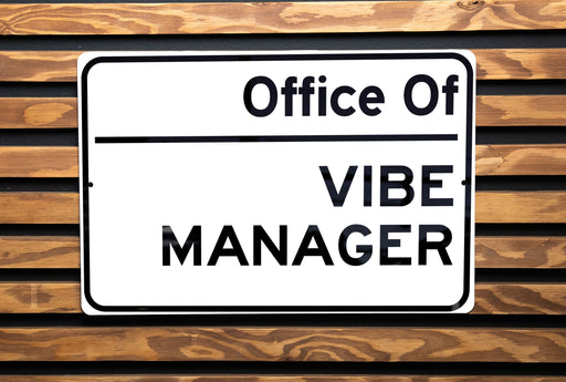 a white sign that is on a wooden bench