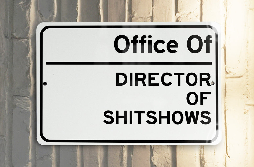 a white and black street sign on a pole