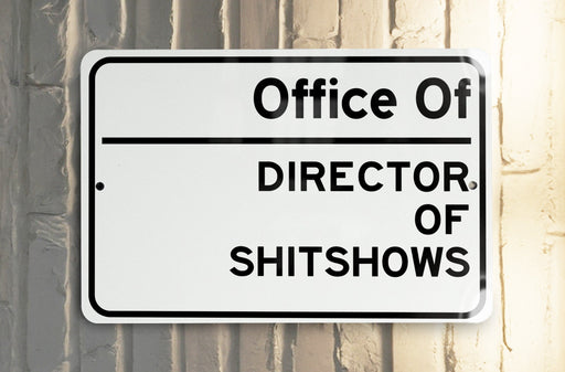 a white and black street sign on a pole