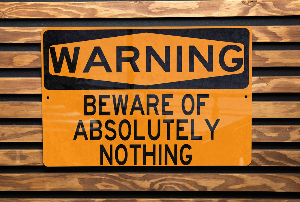 a yellow and black warning sign on a wooden wall
