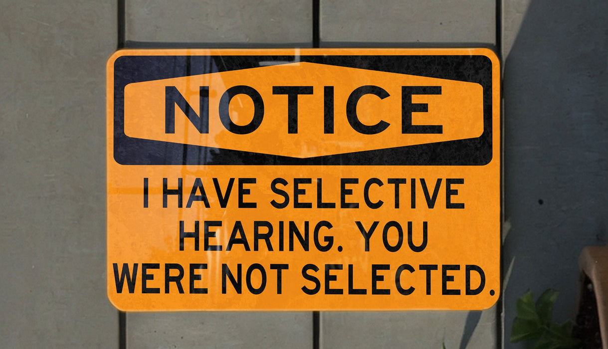a yellow and black sign on a wall