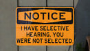 a yellow and black sign on a wall