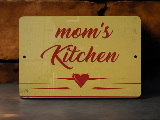 a yellow sign that says mom's kitchen on it
