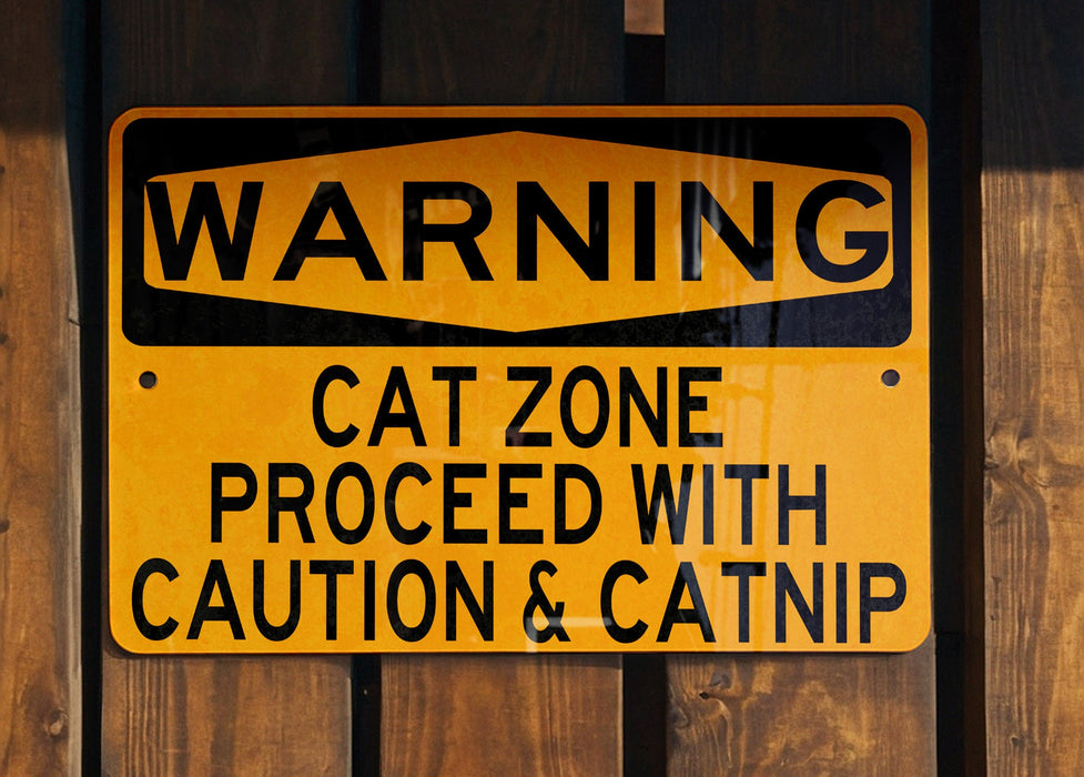 a yellow and black street sign on a wooden fence