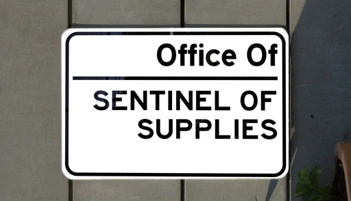 a white street sign sitting on the side of a building