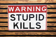 a red and white street sign on a wooden wall