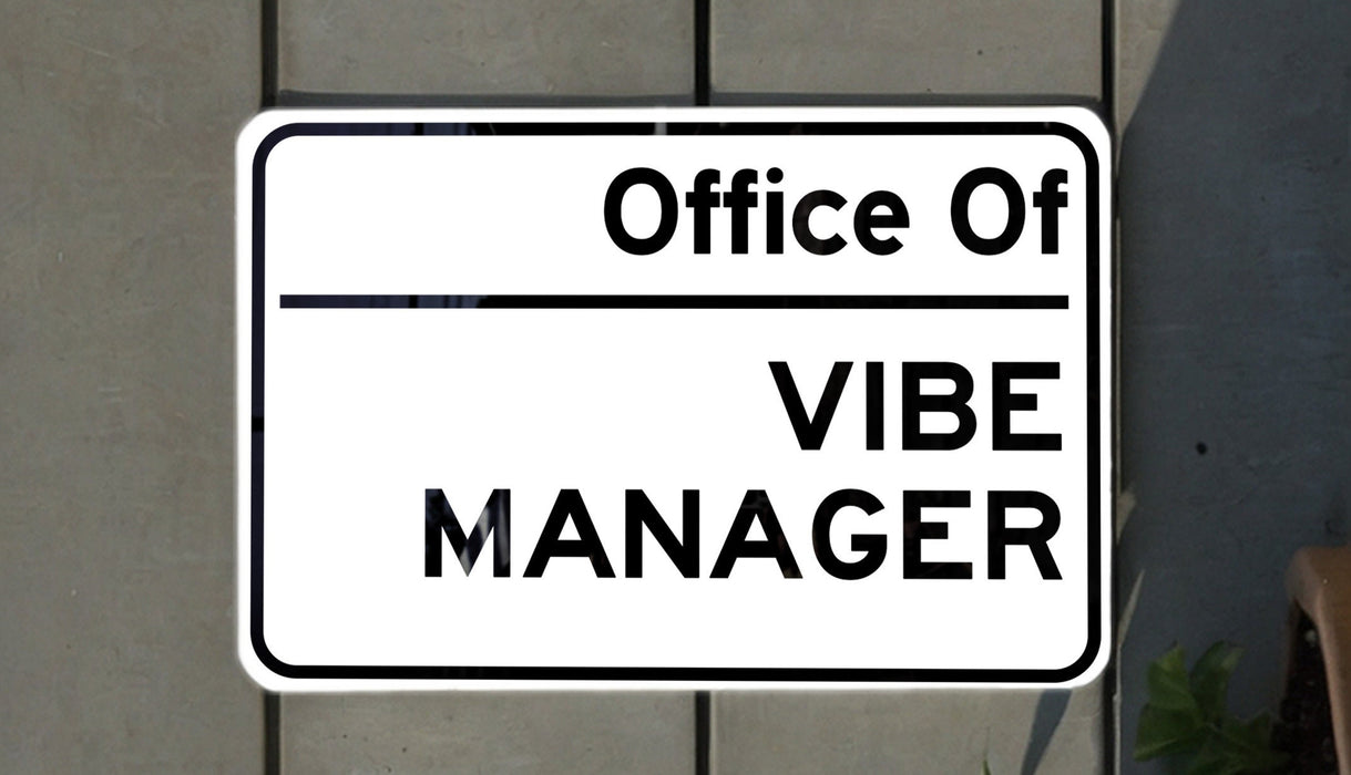 a white and black street sign on a brick wall