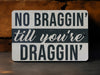 a sign that says no bragin'til you're draggin '
