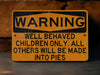 a warning sign on a wall stating children will be made into pies