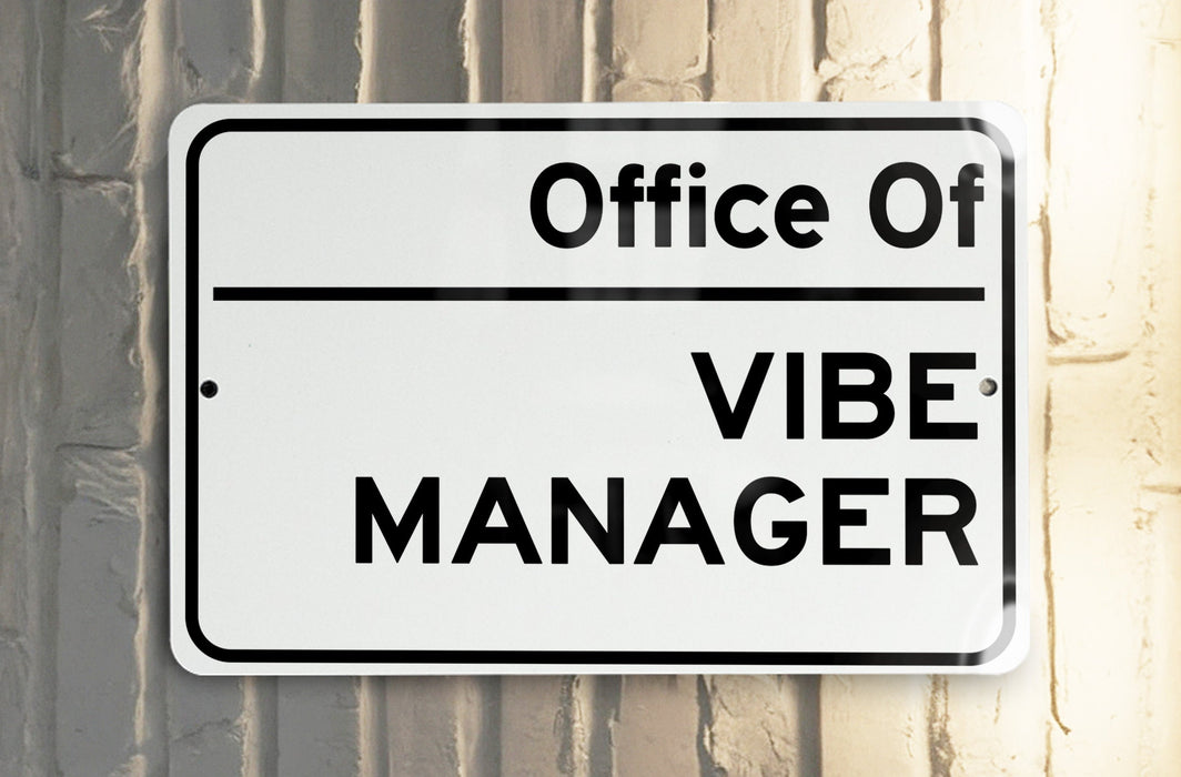 a white and black street sign on a pole