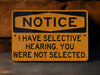 a yellow and black sign that says notice i have selective hearing you were not