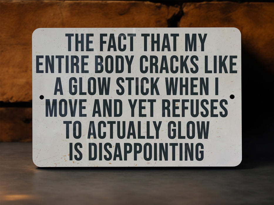 a sign that says the fact that my entire body cracks like a glow stick when