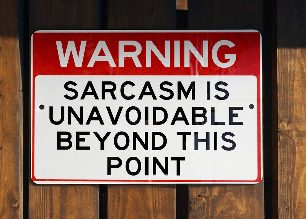 a red and white sign on a wooden fence
