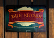 a sign on a wooden fence that says dive kitchen