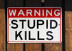 a red and white sign on a wooden fence