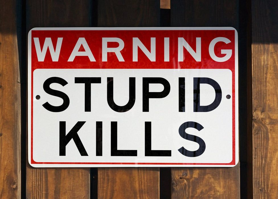 a red and white sign on a wooden fence