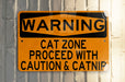 a yellow and black street sign on a pole
