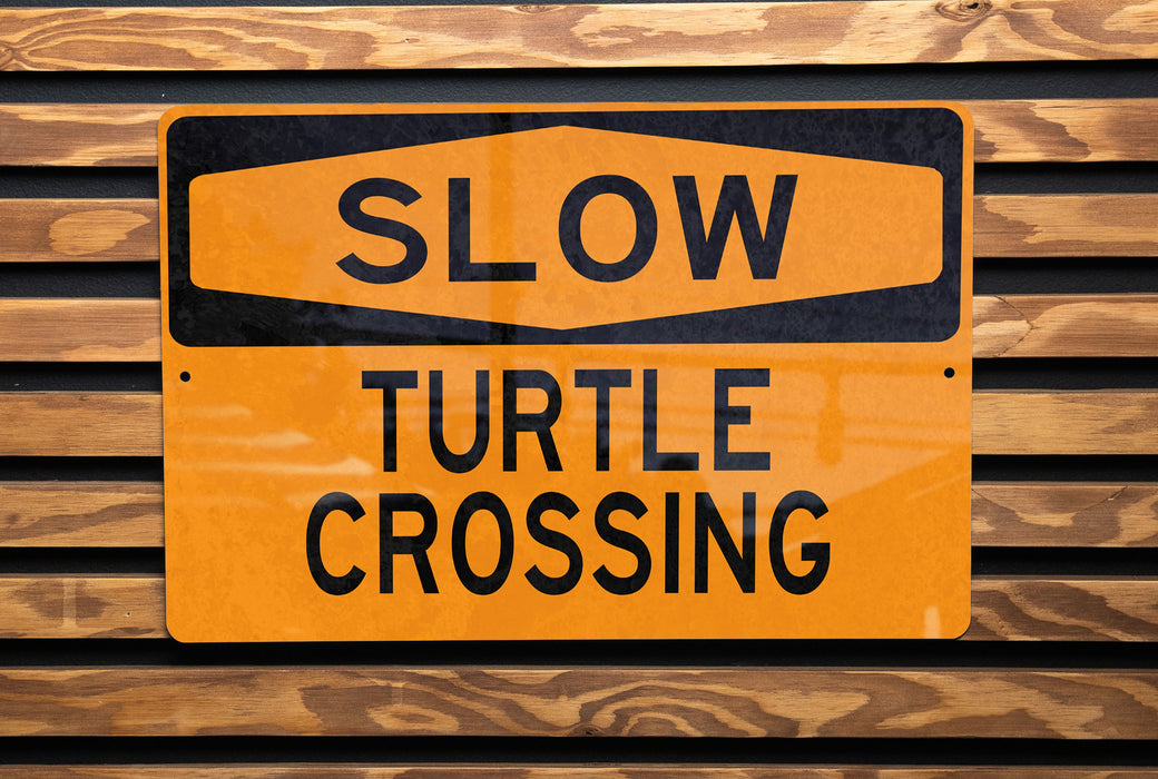 a close up of a street sign on a wooden surface