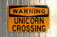 a yellow street sign on a metal pole