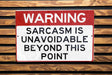 a red and white sign on a wooden wall