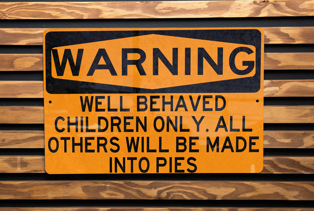a yellow and black sign on a wooden wall