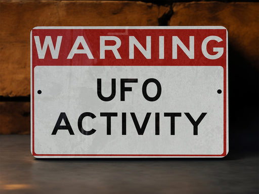 a red and white sign that says warning of ufo activity