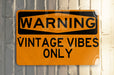 a yellow and black sign on a metal pole
