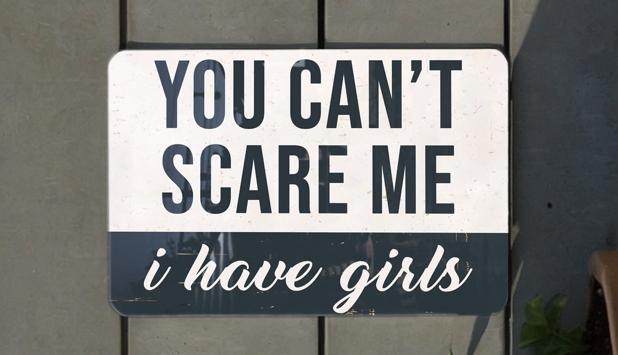 a white and black sign hanging from the side of a building