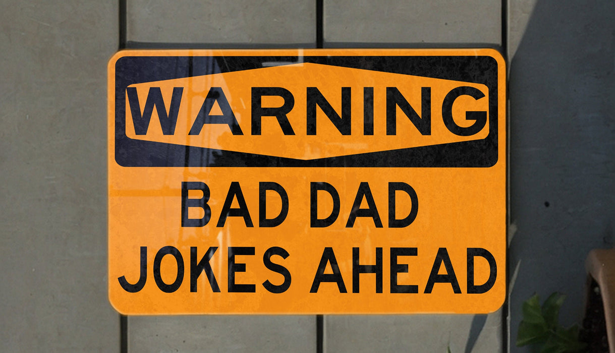 a yellow and black street sign on a wall