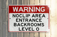 a red and white sign on a metal pole