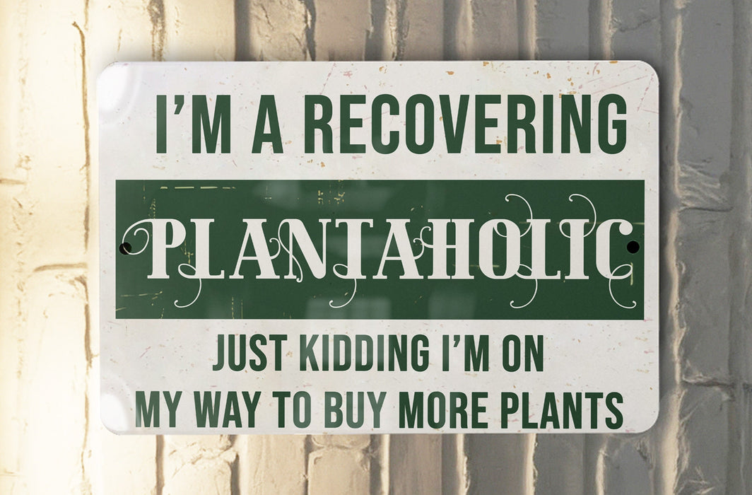 a green and white sign that says i'm a recovering plantaholic