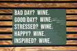 a green sign that says bad day? wine good day? wine stressed?
