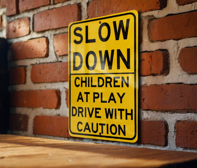 a yellow slow down sign on a brick wall