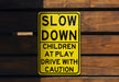 a yellow slow down sign on a wooden wall
