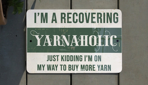 a green and white sign that says i'm a recovering yarnaholic