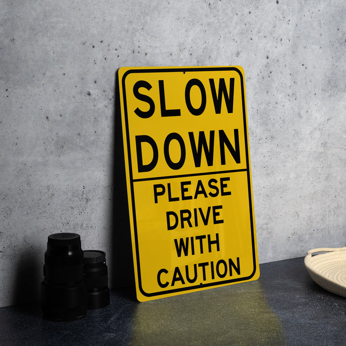 a yellow slow down sign sitting on top of a table