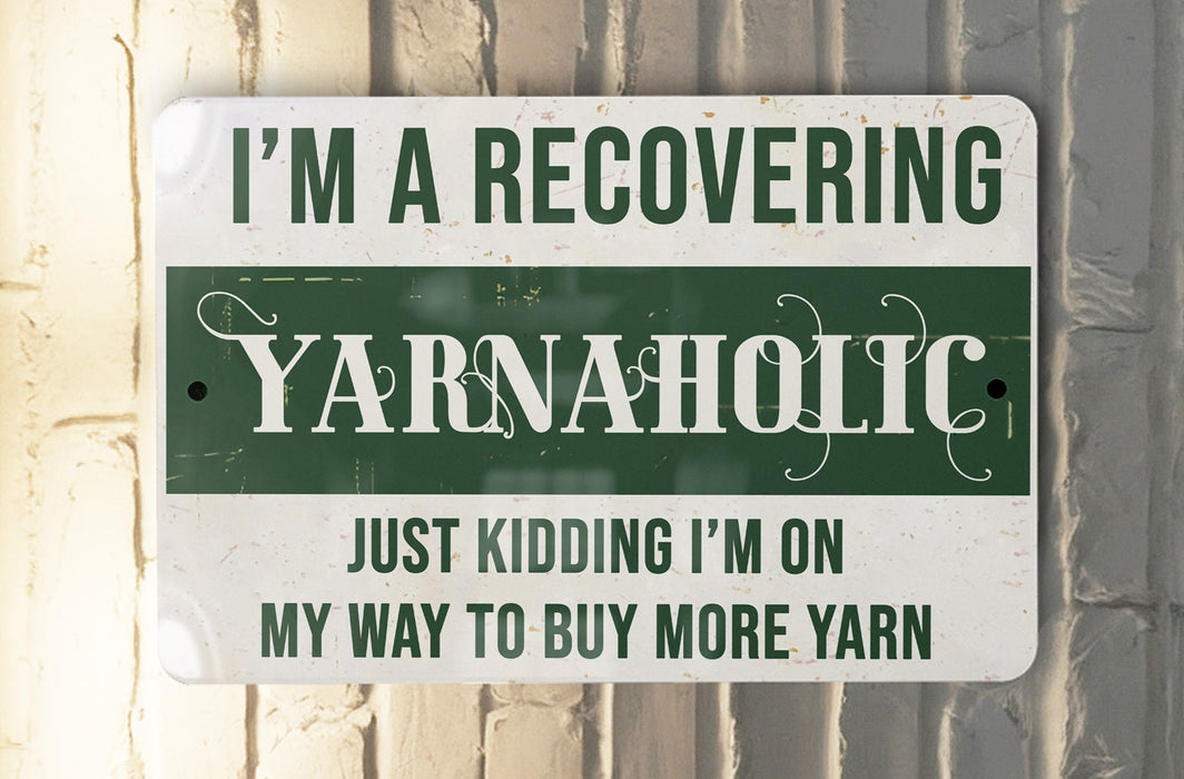 a green and white sign that says i'm a recovering yarnaholic