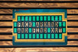 a close up of a sign on a wooden wall