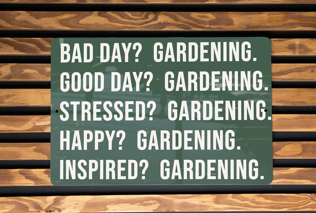 a green sign on a wooden bench that says, bad day gardening good day gardening