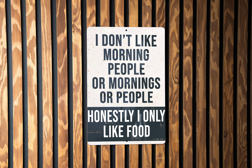 a sign on the side of a building that says i don't like morning