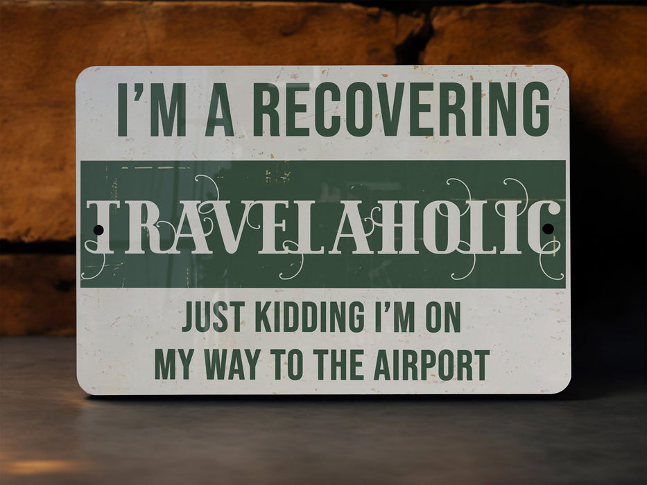 a green and white sign that says i'm a recovering travelaholic