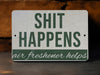 a sign that says shit happens air freshener helps