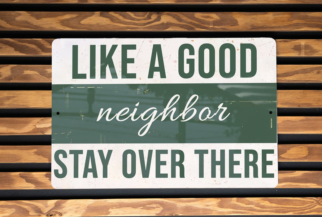 a green and white sign that says like a good neighbor stay over there