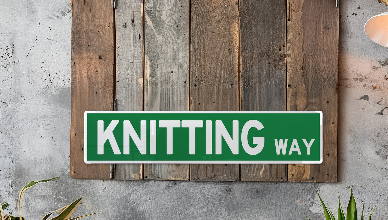 a green and white sign that says knitting way