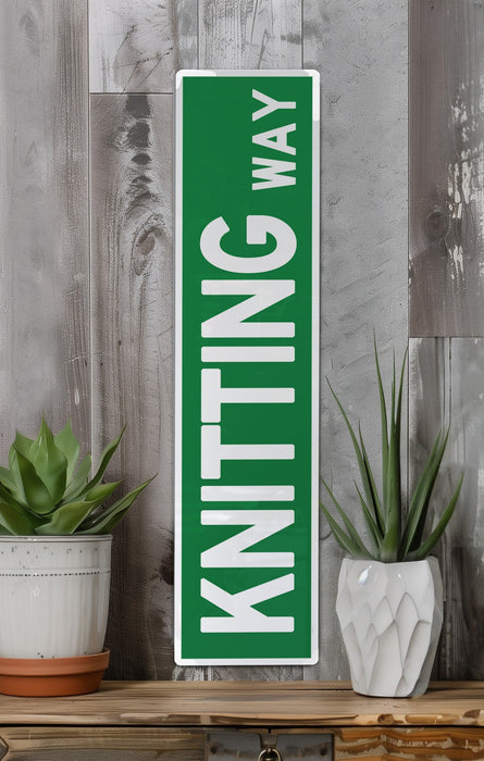 a green street sign sitting on top of a wooden shelf