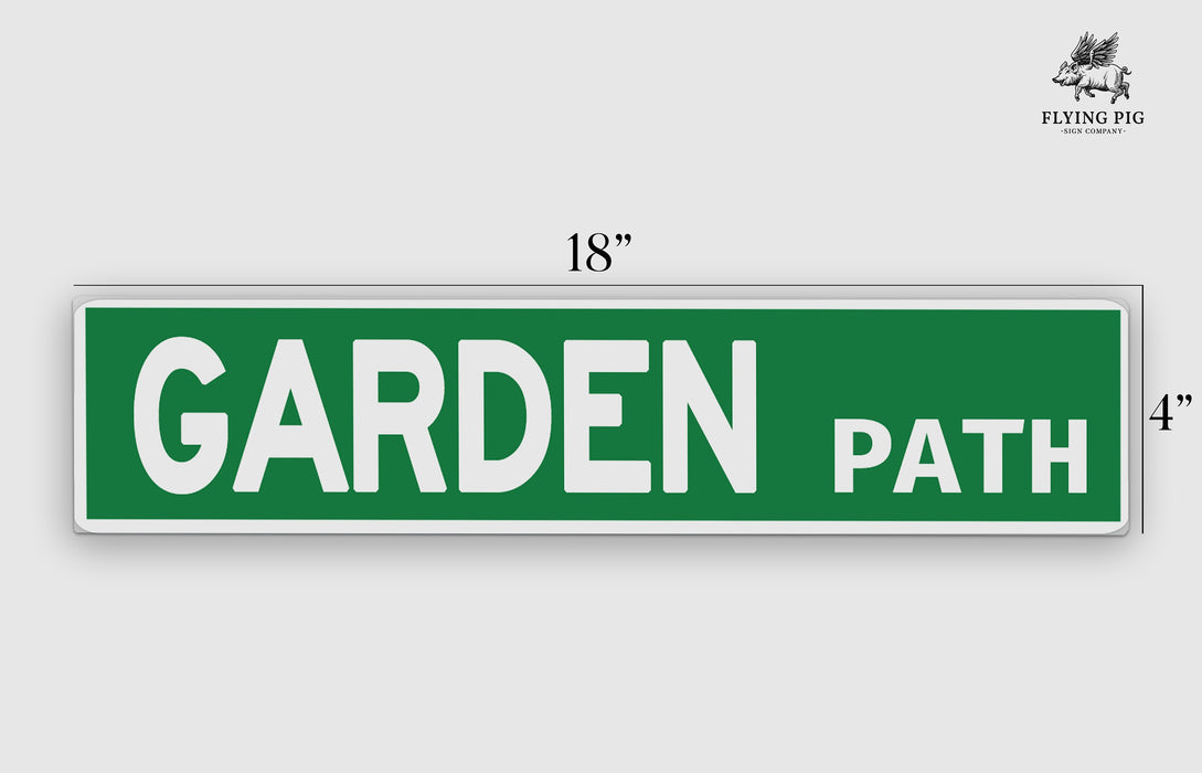 a green street sign that says garden path