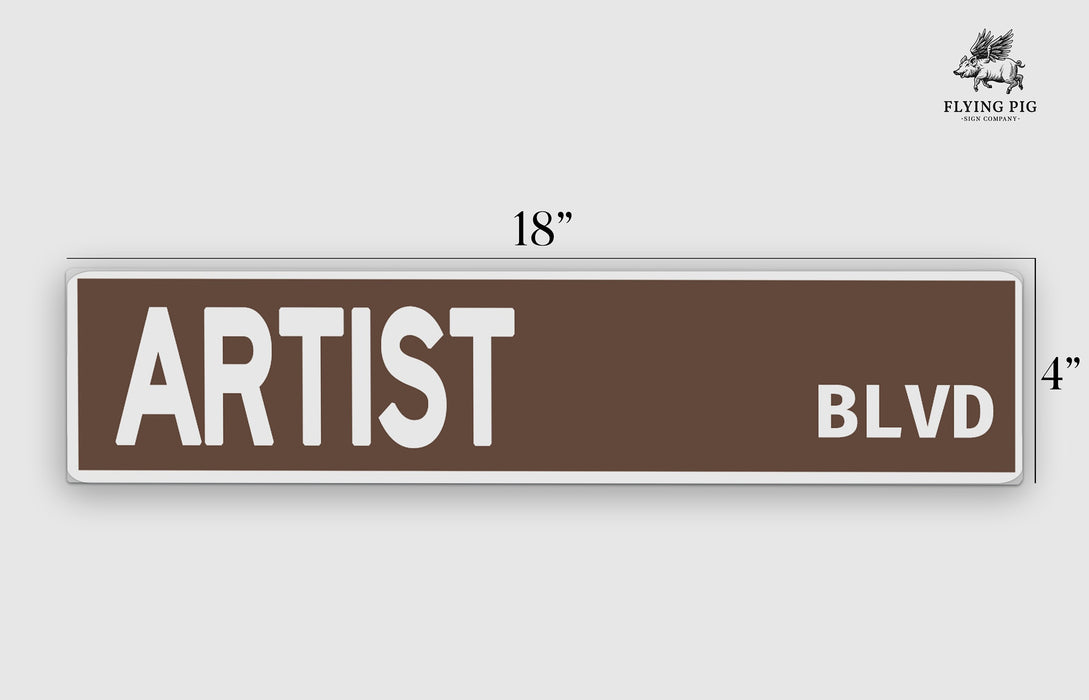 a brown and white street sign that says artist blvd