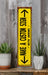 a yellow sign sitting on top of a wooden shelf