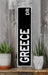 a black and white sign sitting on top of a wooden shelf
